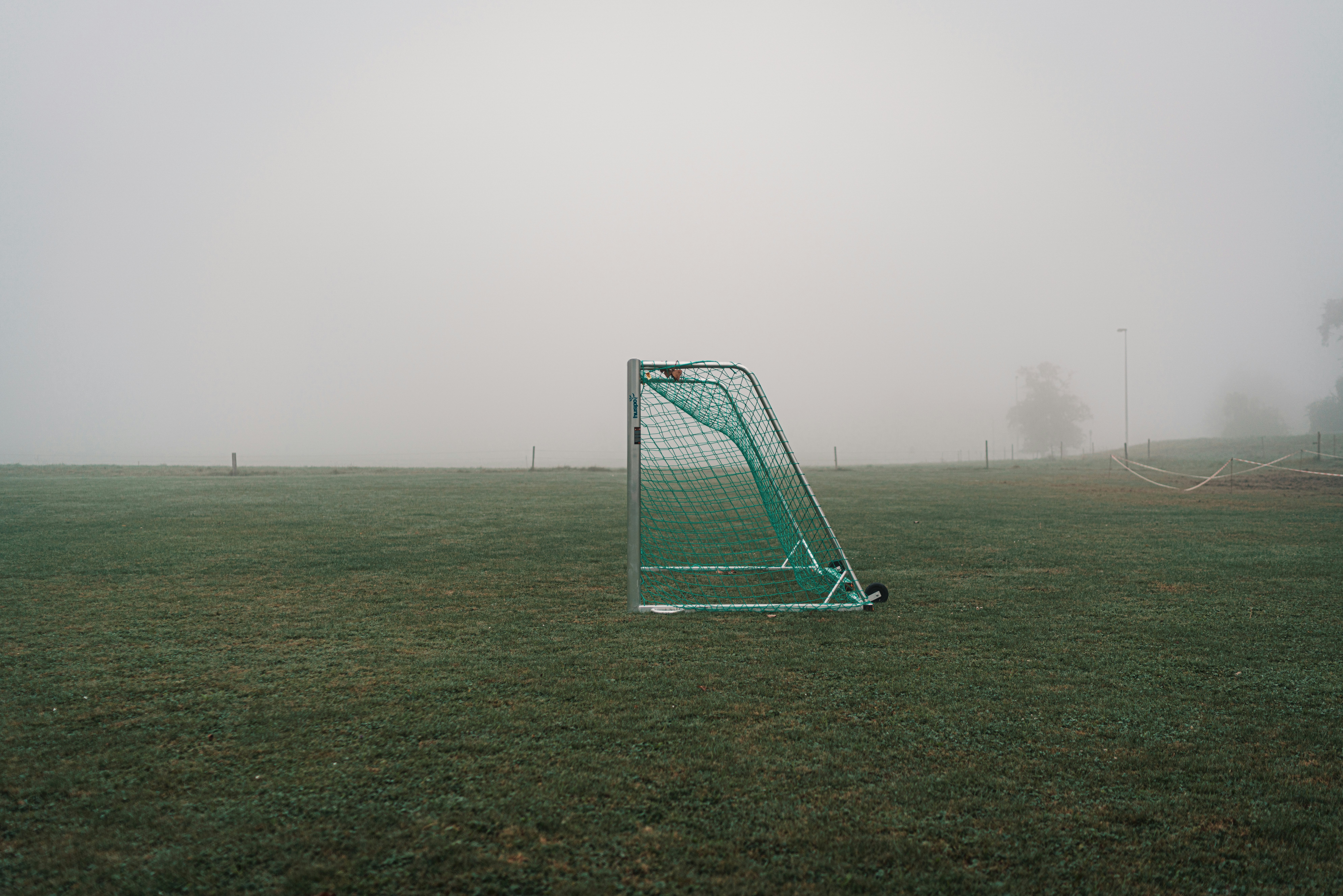 green and white soccer goal net on green grass field